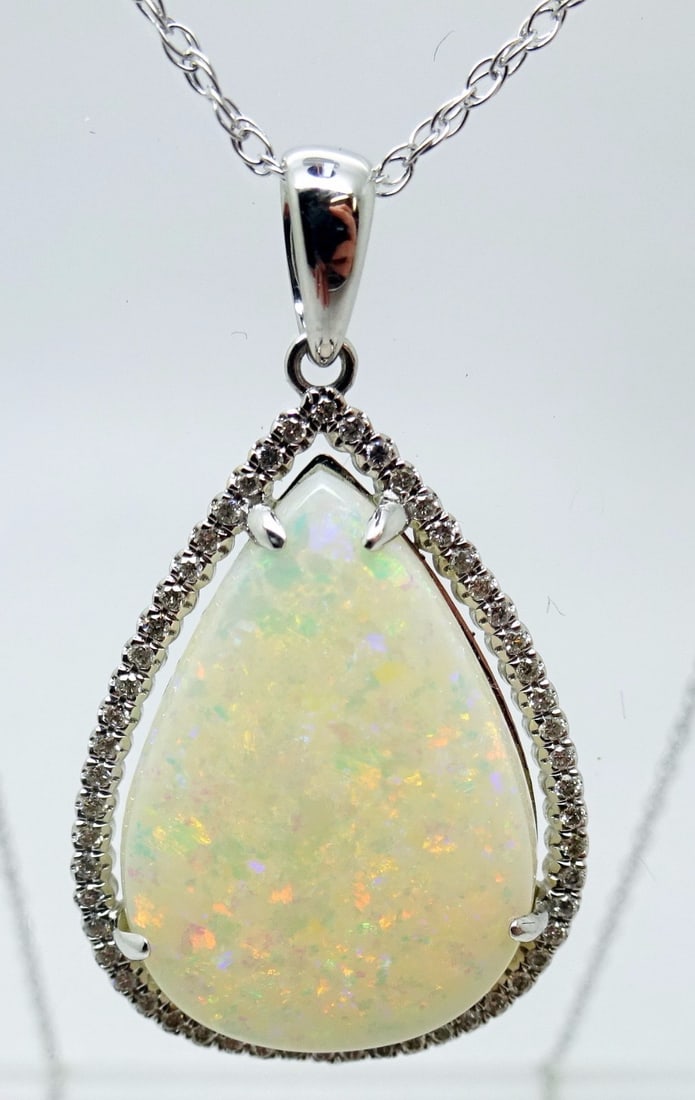 14k White Gold 5.67ct Pear Opal Pendant with .16ct Diamonds GIA Certified: 14k White Gold 5.67ct Pear Opal Pendant with .16ct Diamonds GIA Certified This stunning pendant features a 14k white gold setting, showcasing a magnificent pear-shaped genuine natural opal weighing ap