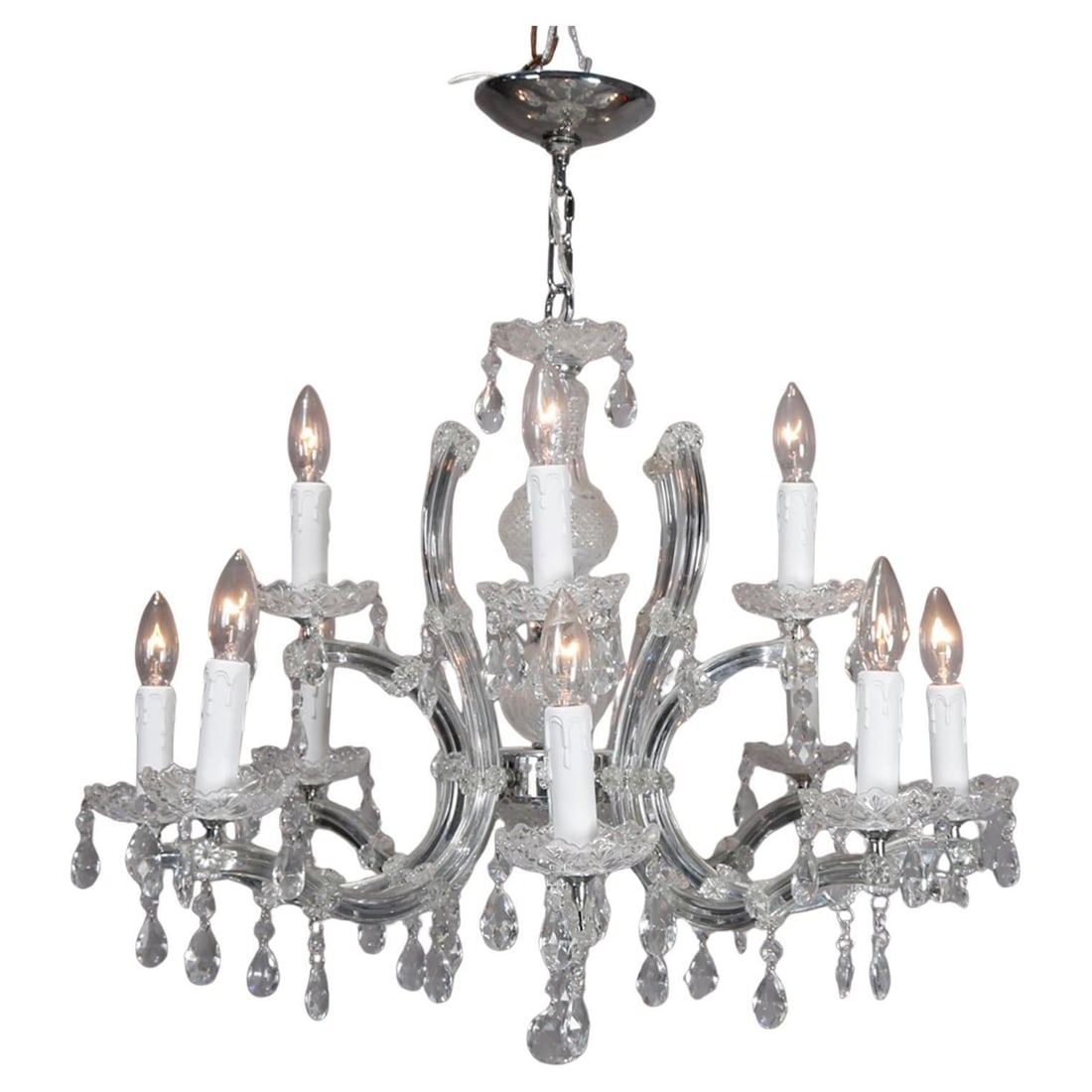 Twelve Arm Chrome and Crystal Chandelier with Cut Crystal Drops 20th Century: Twelve Arm Chrome and Crystal Chandelier with Cut Crystal Drops 20th Century This vintage Italian chandelier features a chrome frame with twelve scroll-form arms, each terminating in a candle-style li