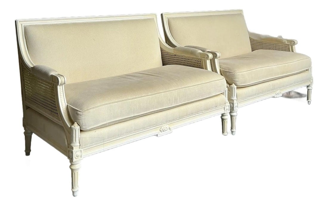 Pair of Hollywood Regency Cane and Upholstered Settees: Pair of Hollywood Regency Cane and Upholstered Settees This pair of vintage Hollywood Regency settees features classic Regency lines with gracefully curved frames, delicate cane webbing on the back an