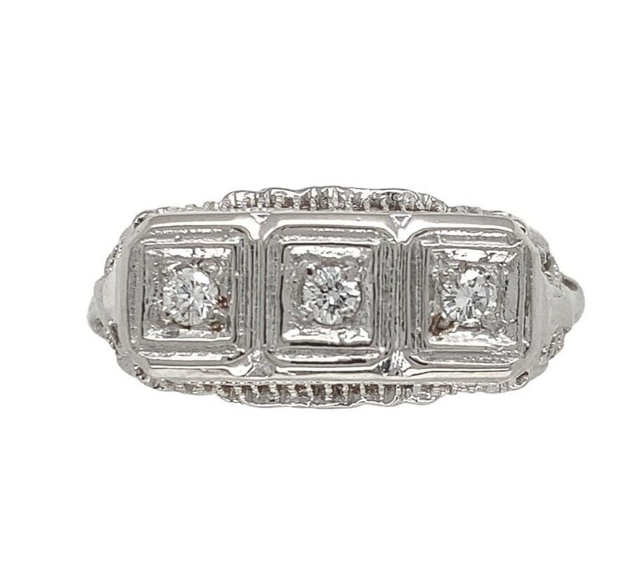 1940s 14k White Gold Filigree Three-Stone Diamond Ring: 1940s 14k White Gold Filigree Three-Stone Diamond Ring This exquisite 14k white gold three-stone filigree ring showcases three stunning round brilliant cut diamonds, each measuring approximately 2.1mm