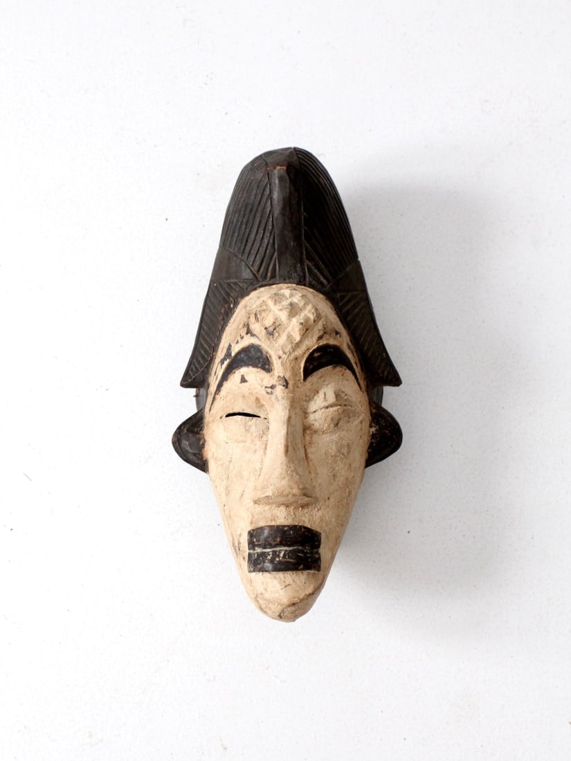 Vintage Hand-Carved Punu African Tribal Wall Mask 13x6.5x6: Vintage Hand-Carved Punu African Tribal Wall Mask 13x6.5x6 This vintage African tribal mask from the Punu people is a stunning hand-carved piece made from wood, featuring striking black and white pain