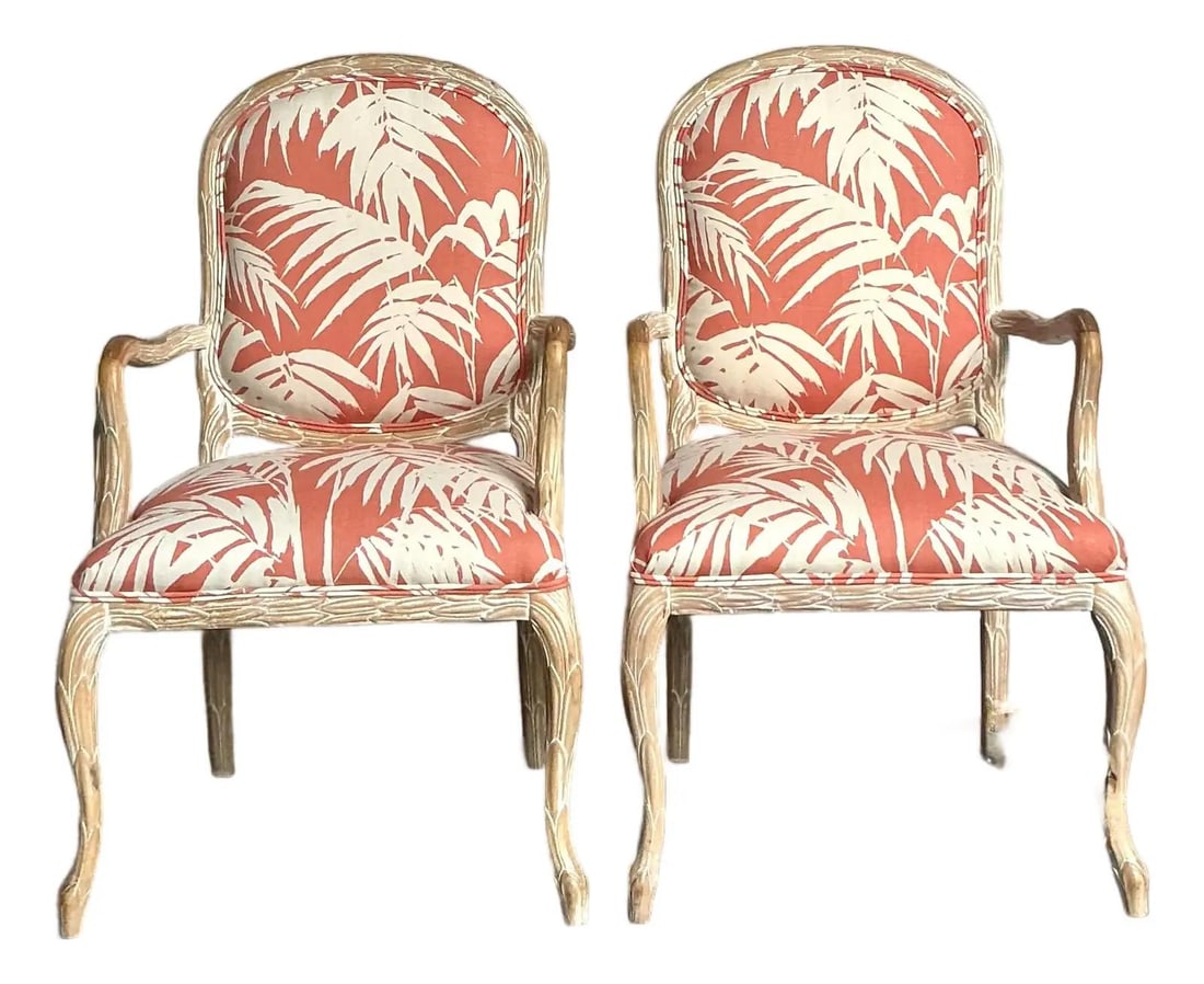 Pair of Faux Bois French Fauteuil Armchairs in Palm Leaf Upholstery: Pair of Faux Bois French Fauteuil Armchairs in Palm Leaf Upholstery This pair of vintage Regency-style armchairs is crafted in the classic French fauteuil design, featuring curved wood frames with cab
