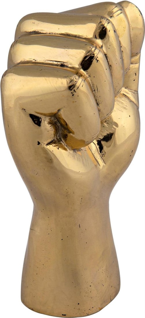 Unity and Strength Solidarity Fist Sculpture Brass by Noir: Unity and Strength Solidarity Fist Sculpture Brass by Noir Introducing the Unity and Strength Solidarity Fist Sculpture, a striking piece that embodies resilience and support. Crafted in a vintage sty