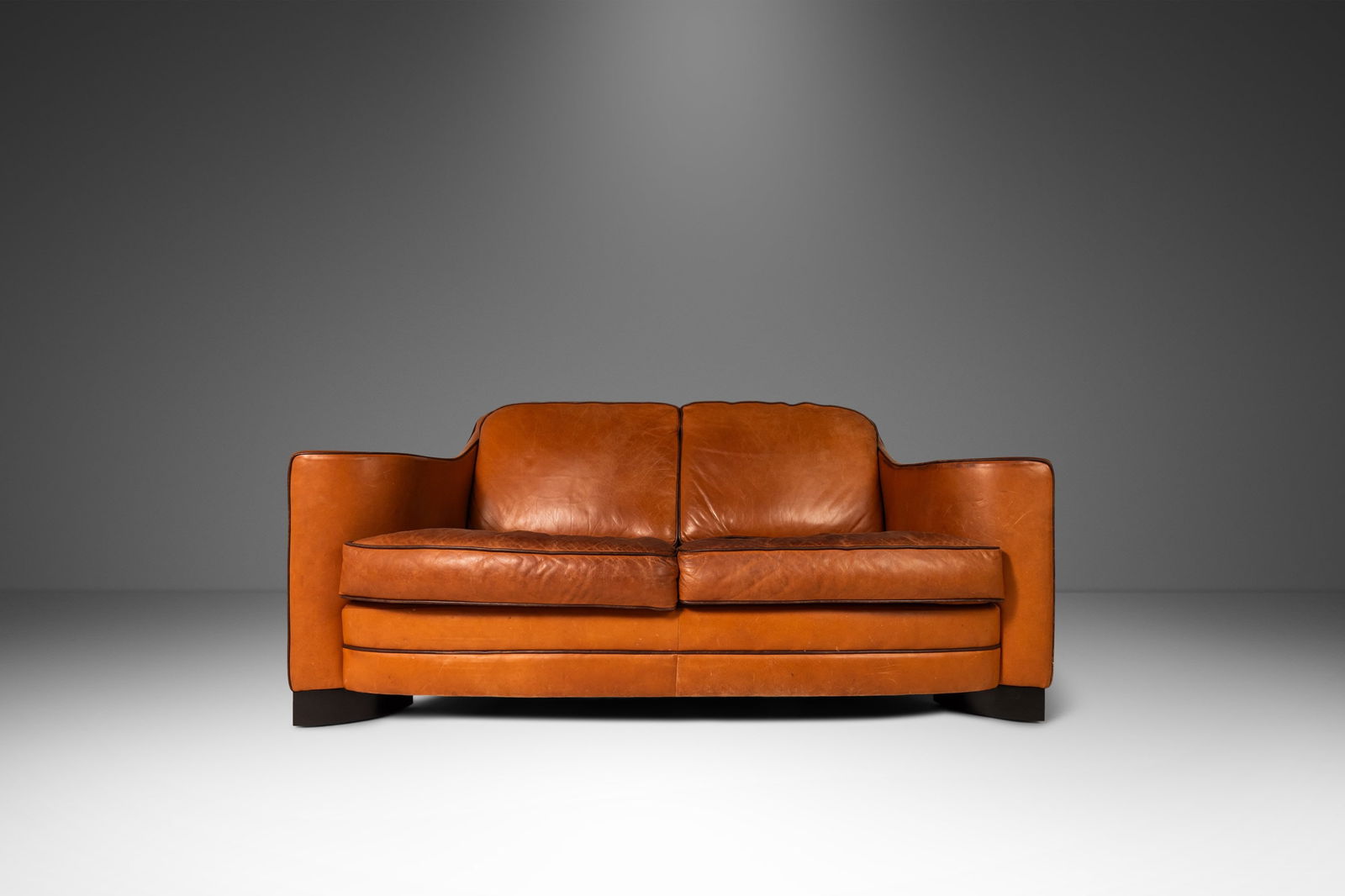 1970s Art Deco Mid-Century Modern Loveseat Sofa Patinaed Leather Sculptural Arms USA: 1970s Art Deco Mid-Century Modern Loveseat Sofa Patinaed Leather Sculptural Arms USA Discover this architecturally stunning Art Deco Mid-Century Modern Loveseat Sofa with sculptural arms and original