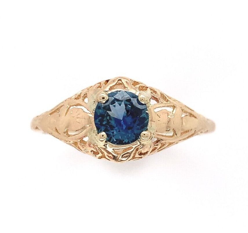 14k Yellow Gold Art Deco Filigree Ring with .63ct Blue Sapphire: 14k Yellow Gold Art Deco Filigree Ring with .63ct Blue Sapphire This exquisite 14k Yellow Gold Filigree Ring showcases a stunning genuine natural sapphire weighing .63 carats. The sapphire, with a rou