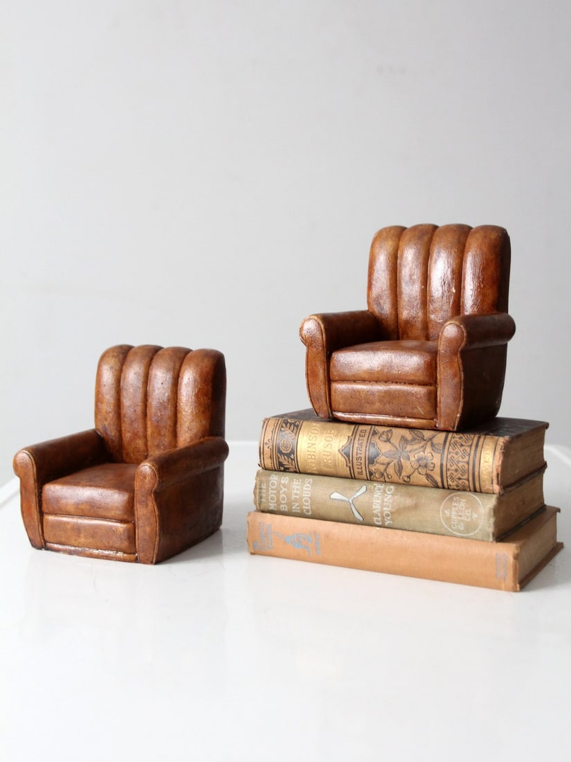 Pair of Vintage Club Chair Shaped Bookends in Brown Finish: Pair of Vintage Club Chair Shaped Bookends in Brown Finish This pair of vintage bookends is designed in the form of classic overstuffed club chairs, featuring a warm brown finish reminiscent of aged l