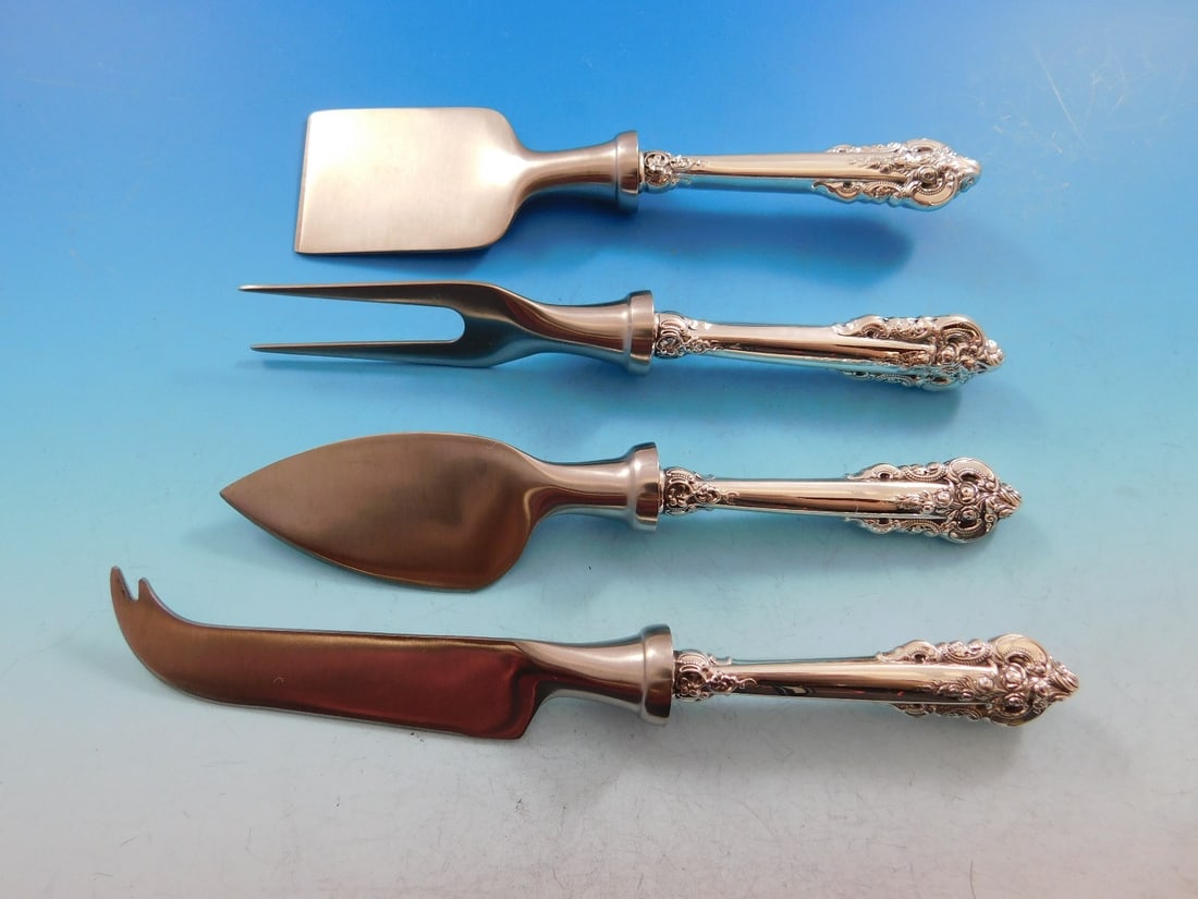 Wallace Grande Baroque Sterling Silver 4pc Cheese Serving Set: Wallace Grande Baroque Sterling Silver 4pc Cheese Serving Set Enhance your cheese serving experience with this exquisite 4-piece cheese serving set from the Grande Baroque pattern by Wallace. Crafted