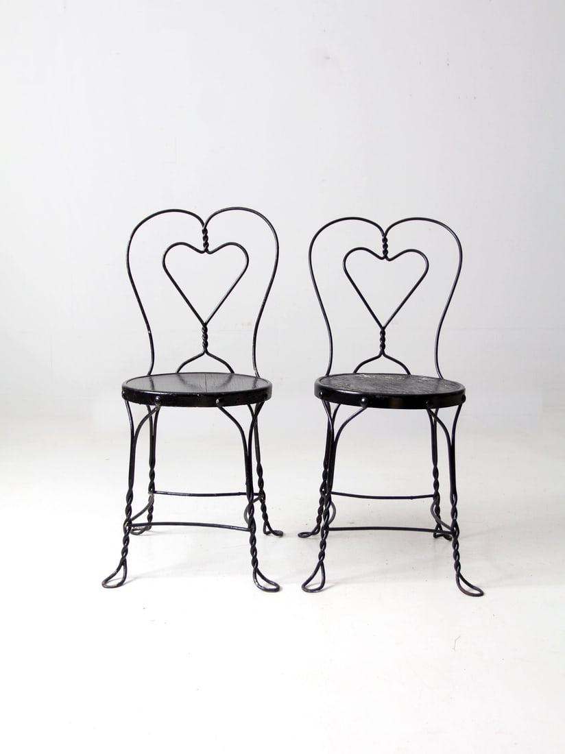 Vintage Pair of Black Metal Ice Cream Parlor Chairs with Heart Design: Vintage Pair of Black Metal Ice Cream Parlor Chairs with Heart Design This pair of vintage ice cream parlor chairs combines timeless appeal with a touch of nostalgia. Crafted from black metal, these c