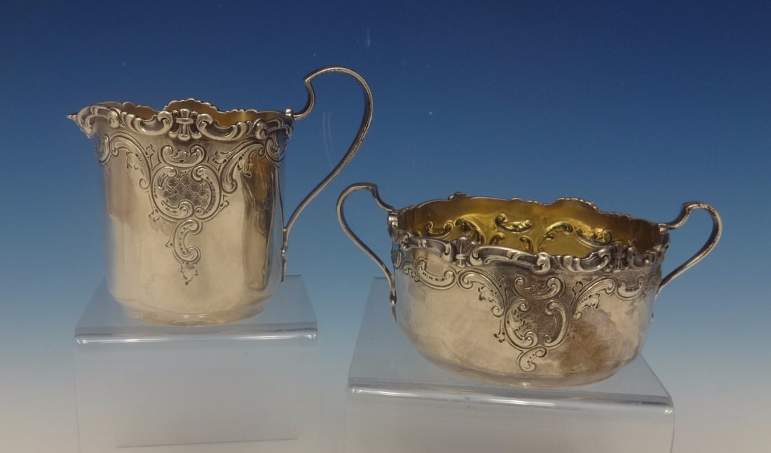 Dominick & Haff Sterling Silver 2pc Sugar Bowl and Creamer Set Repousse Design: Dominick & Haff Sterling Silver 2pc Sugar Bowl and Creamer Set Repousse Design This exquisite 2-piece sugar bowl and creamer set, crafted by Dominick & Haff in 1891, showcases the elegance of sterling