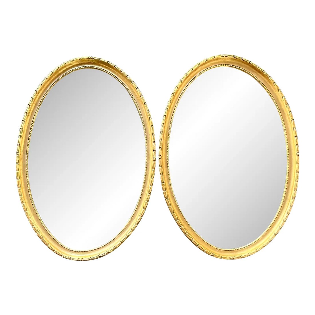Pair of Neoclassical Gilt Laurel Leaf Oval Mirrors with Beaded Trim: Pair of Neoclassical Gilt Laurel Leaf Oval Mirrors with Beaded Trim This pair of vintage Hollywood Regency oval mirrors features Neoclassical-inspired frames adorned with a continuous laurel leaf wrea