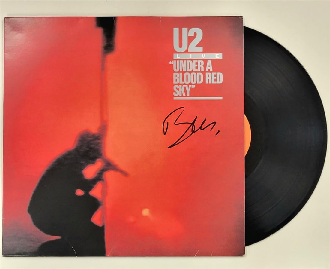Bono Autographed Under a Blood Red Sky Album Cover JSA Authenticated: Bono Autographed Under a Blood Red Sky Album Cover JSA Authenticated This is an original U2 "Under A Blood Red Sky" vinyl album cover, signed by Bono. The autograph has been authenticated by James Spe
