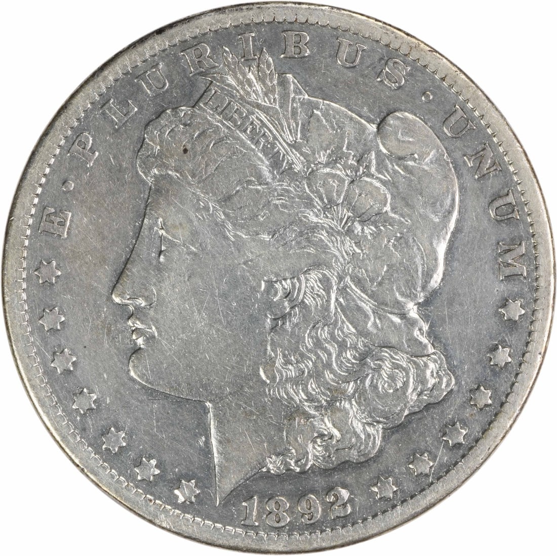 1892-CC Morgan Silver Dollar VF Uncertified 90% Silver Coin: 1892-CC Morgan Silver Dollar VF Uncertified 90% Silver Coin This 1892-CC Morgan Silver Dollar is a classic piece of American numismatic history, featuring a striking design by George T. Morgan. The co