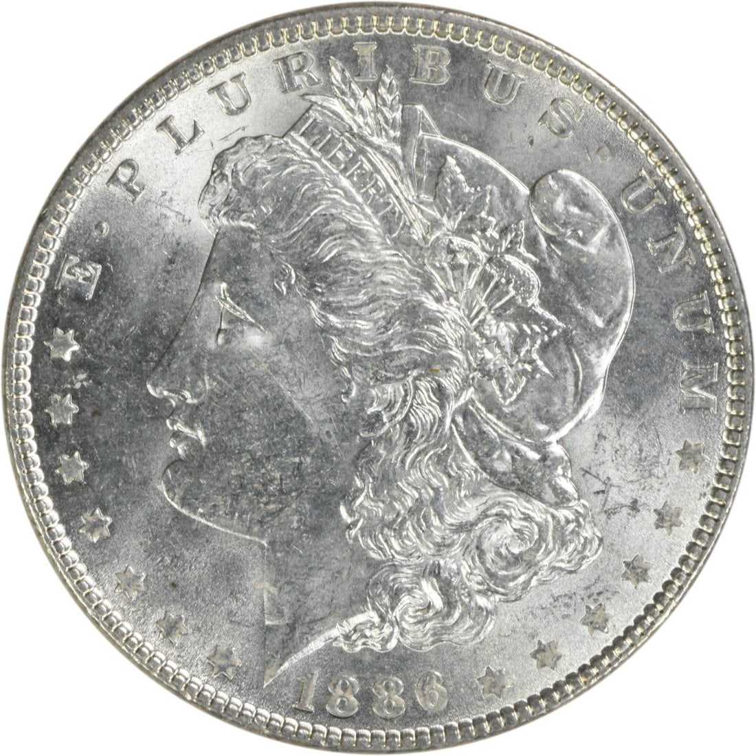 1886 Morgan Silver Dollar Choice BU Uncertified Silver Coin: 1886 Morgan Silver Dollar Choice BU Uncertified Silver Coin This 1886 Morgan Silver Dollar is an exquisite piece, showcasing a stunning uncirculated condition with a Choice BU grade. Featuring a silve