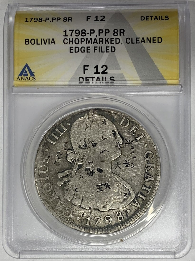 Silver 1798 Bolivia 8 Reals Coin ANACS F12 Chopmarked Certified: Silver 1798 Bolivia 8 Reals Coin ANACS F12 Chopmarked Certified This 1798-P Bolivia 8 Reals coin is composed of silver and has been certified by ANACS with a grade of F 12 Details. The coin is circula