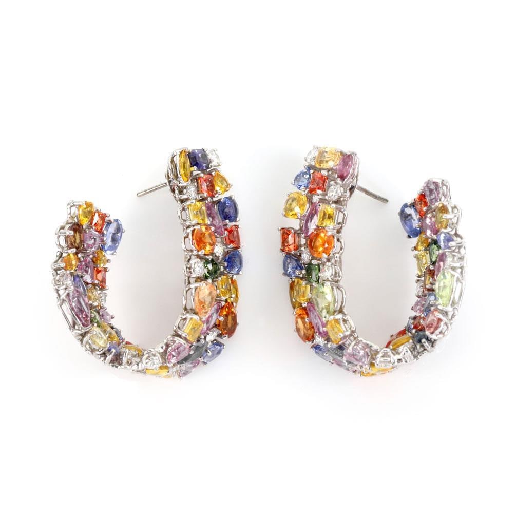 Elegant 18k White Gold Twist Earrings with 60 Carats Multicolor Sapphires and Diamonds: Elegant 18k White Gold Twist Earrings with 60 Carats Multicolor Sapphires and Diamonds These stunning earrings are crafted from 18k white gold and feature a unique twist oval hoop design. Measuring 1.