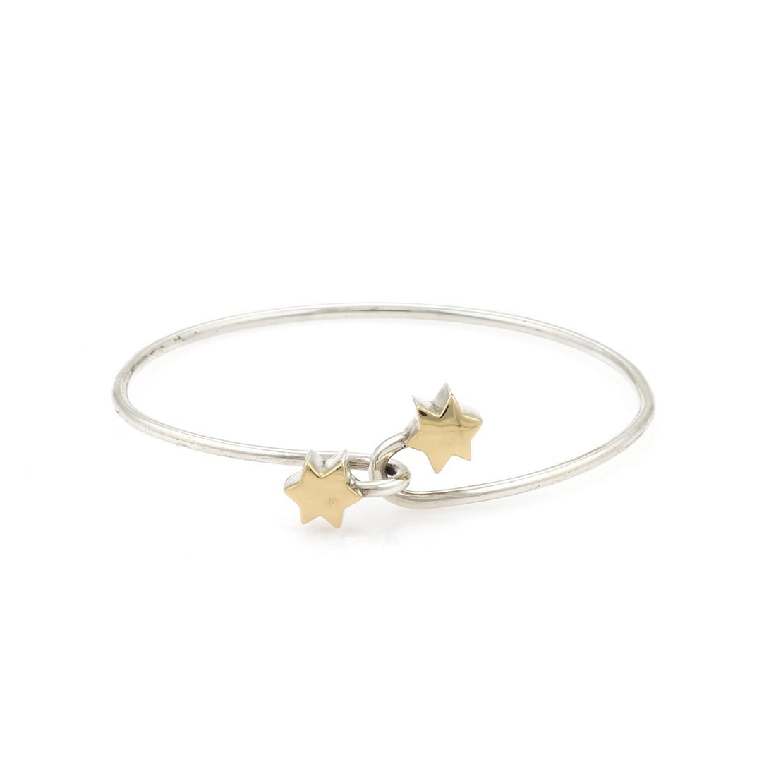 Tiffany & Co. Sterling Silver 18k Yellow Gold Star Bangle Bracelet: Tiffany & Co. Sterling Silver 18k Yellow Gold Star Bangle Bracelet This exquisite bangle bracelet from Tiffany & Co. showcases a stunning blend of sterling silver and 18k yellow gold. The bracelet fea