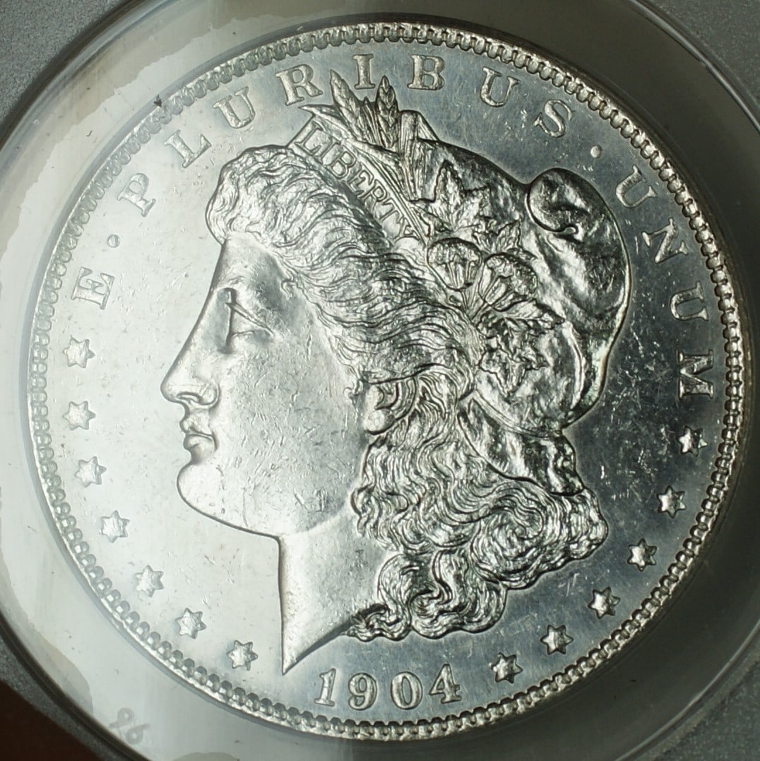 ANACS AU-58 Details 1904-O Morgan Dollar Silver Coin Proof-Like New Orleans Mint: ANACS AU-58 Details 1904-O Morgan Dollar Silver Coin Proof-Like New Orleans Mint This is a 1904-O Morgan Silver Dollar $1 coin certified by ANACS with an AU-58 Details grade. The coin has been cleaned