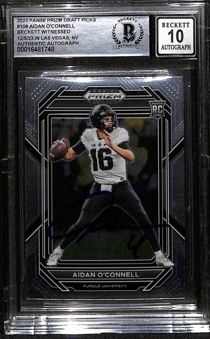 2023 Panini Prizm Football Card Aidan O'Connell Beckett 10 Witnessed Auto: 2023 Panini Prizm Football Card Aidan O'Connell Beckett 10 Witnessed Auto This is an original 2023 Panini Prizm #108 football trading card featuring Aidan O'Connell, quarterback for the Las Vegas Raid