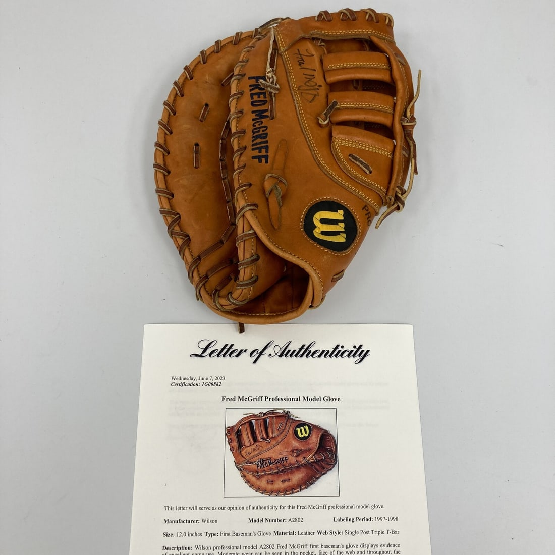 1997 Fred McGriff Signed Game Used Wilson A2802 Glove with PSA DNA COA: 1997 Fred McGriff Signed Game Used Wilson A2802 Glove with PSA DNA COA This is a game-used Wilson baseball glove model A2802, signed by Fred McGriff, a prominent player in Major League Baseball. The g