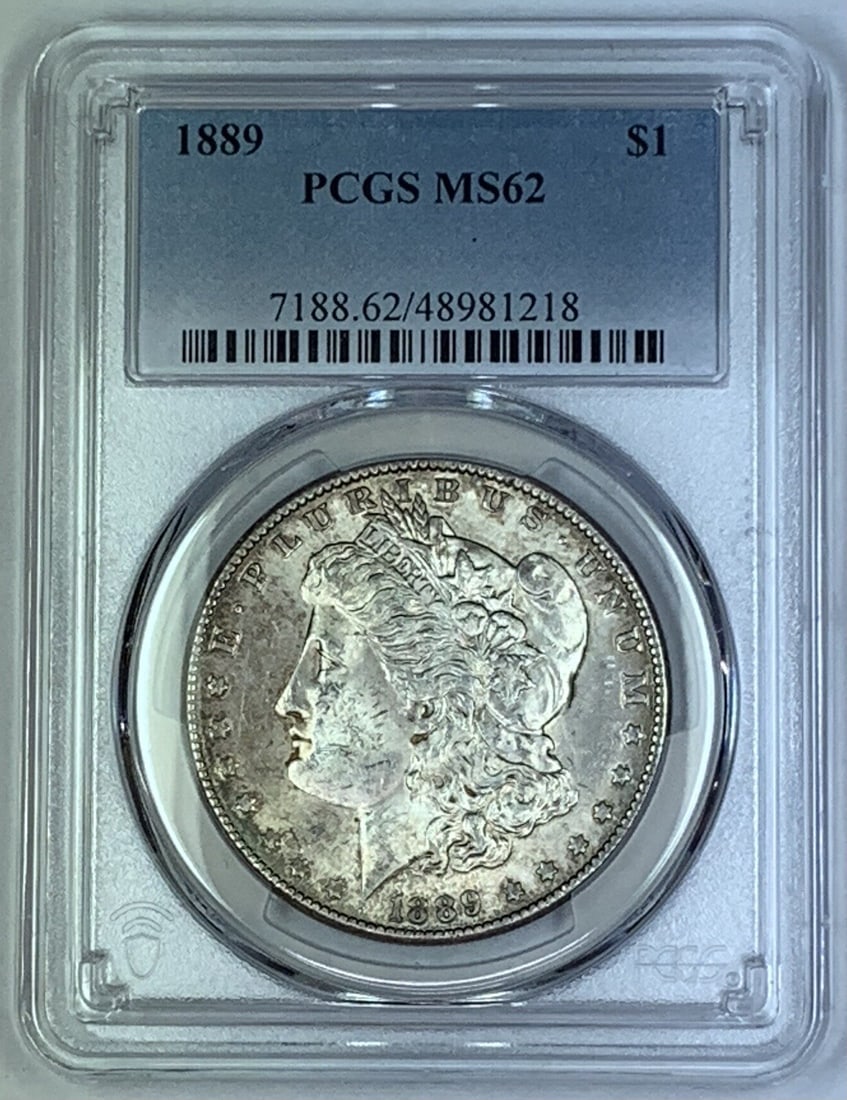 PCGS MS 62 1889 Morgan Silver Dollar Toned Uncirculated Coin: PCGS MS 62 1889 Morgan Silver Dollar Toned Uncirculated Coin This 1889 Morgan Silver Dollar is a toned coin graded MS 62 by PCGS. It is uncirculated and features the classic Morgan design. The coin is