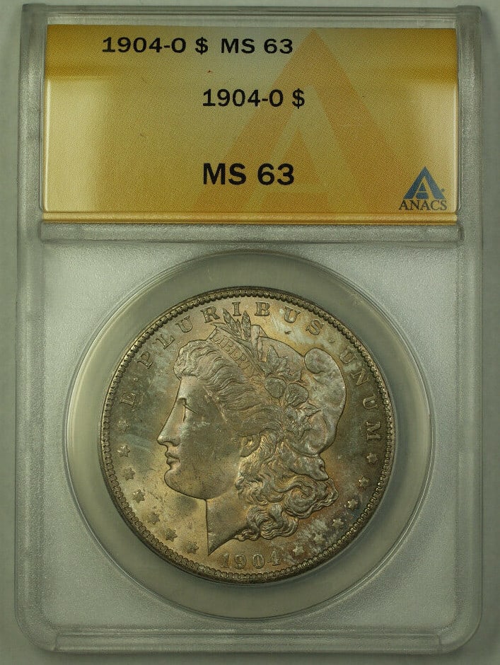 ANACS MS63 1904-O Toned Morgan Dollar New Orleans Mint Silver Coin: ANACS MS63 1904-O Toned Morgan Dollar New Orleans Mint Silver Coin This 1904-O Morgan Silver Dollar is an un-used coin certified by ANACS with a grade of MS 63. Struck at the New Orleans Mint, it feat