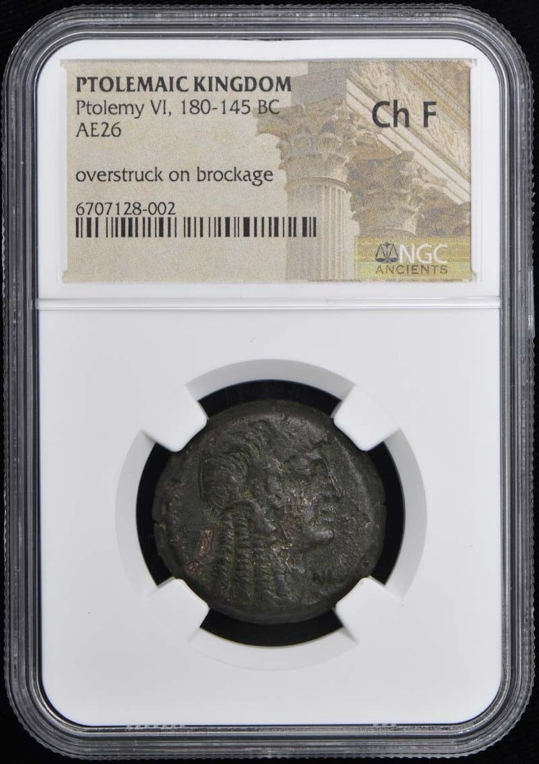 AE26 Ancient Coin of Ptolemy VI Overstrike NGC Certified F15: AE26 Ancient Coin of Ptolemy VI Overstrike NGC Certified F15 This is an ancient bronze coin from the Ptolemaic Kingdom, issued during the reign of Ptolemy VI between 180 and 145 BC. The coin has been