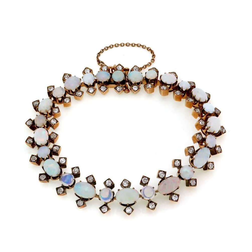 Victorian 18k Gold Fancy Bracelet with 18.00ct Diamonds and Fire Opals: Victorian 18k Gold Fancy Bracelet with 18.00ct Diamonds and Fire Opals This exquisite vintage bracelet showcases a stunning design crafted from 18k yellow gold. It features a triple row arrangement wi