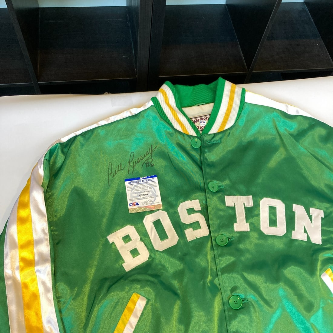 Bill Russell Signed 1956 Celtics Jacket with PSA DNA COA: Bill Russell Signed 1956 Celtics Jacket with PSA DNA COA This authentic 1956 Mitchell & Ness Boston Celtics jacket features the legendary Bill Russell's signature, authenticated by PSA DNA. A must-hav