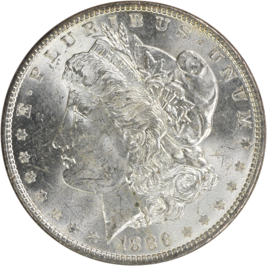 1886 Morgan Silver Dollar BU Uncertified Silver Coin: 1886 Morgan Silver Dollar BU Uncertified Silver Coin This 1886 Morgan Silver Dollar is a beautiful uncirculated piece, showcasing the classic design of the Morgan series. Made of silver, this coin has
