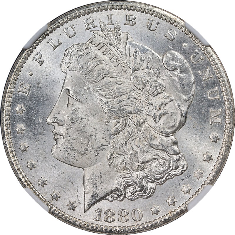 NGC MS63 1880 Carson City Morgan Silver Dollar with Exceptional Luster: NGC MS63 1880 Carson City Morgan Silver Dollar with Exceptional Luster This original 1880-CC Morgan Silver Dollar is graded MS63 by NGC and features a strong strike with excellent eye appeal. The coin