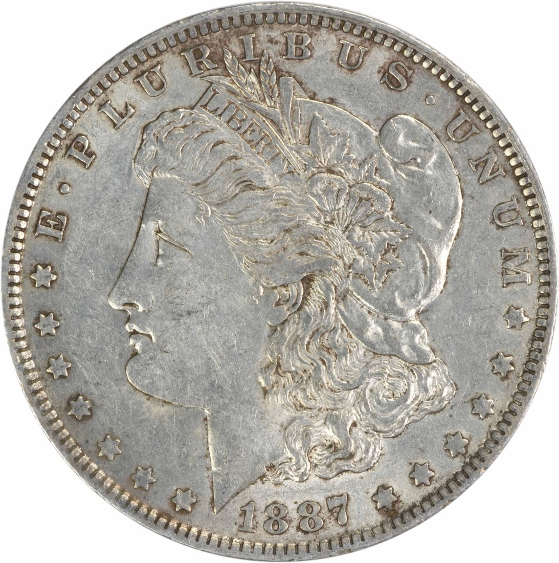 1887-O Morgan Silver Dollar AU Uncertified New Orleans Coin: 1887-O Morgan Silver Dollar AU Uncertified New Orleans Coin This 1887-O Morgan Silver Dollar is an exceptional collectible coin, showcasing the artistry of designer George T. Morgan. This circulated c