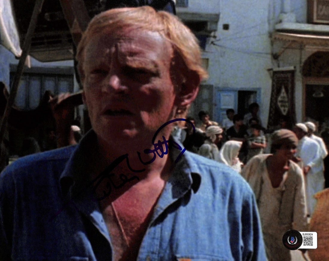 Robert Watts Signed 8x10 Raiders of the Lost Ark Photo Beckett Certified: Robert Watts Signed 8x10 Raiders of the Lost Ark Photo Beckett Certified This authentic 8x10 color photograph captures a behind-the-scenes moment from Raiders of the Lost Ark (1981), signed boldly in