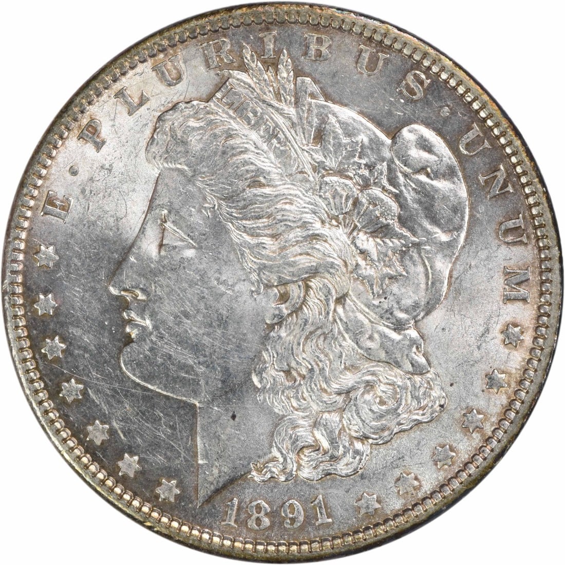 1891 Morgan Silver Dollar AU Uncertified 90% Silver Coin: 1891 Morgan Silver Dollar AU Uncertified 90% Silver Coin This 1891 Morgan Silver Dollar is a remarkable piece of American history, featuring a striking design by George T. Morgan. It is classified as
