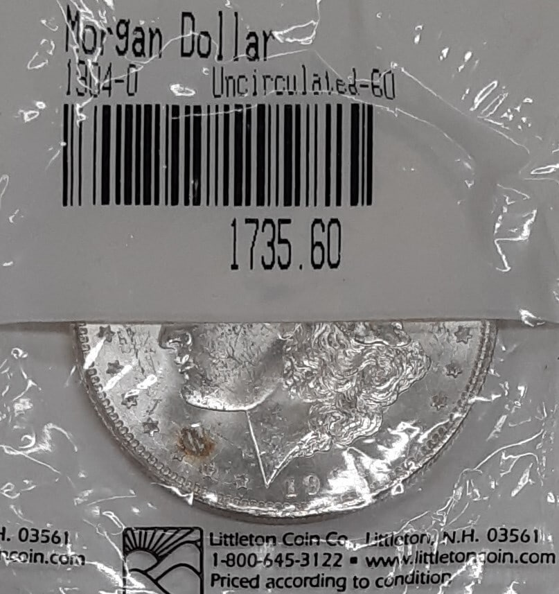 Uncirculated 1904-O Silver Morgan Dollar in Littleton Holder: Uncirculated 1904-O Silver Morgan Dollar in Littleton Holder This is a 1904-O Morgan Silver Dollar $1 coin from the United States, featuring a silver composition with a fineness of 0.9. The coin is un