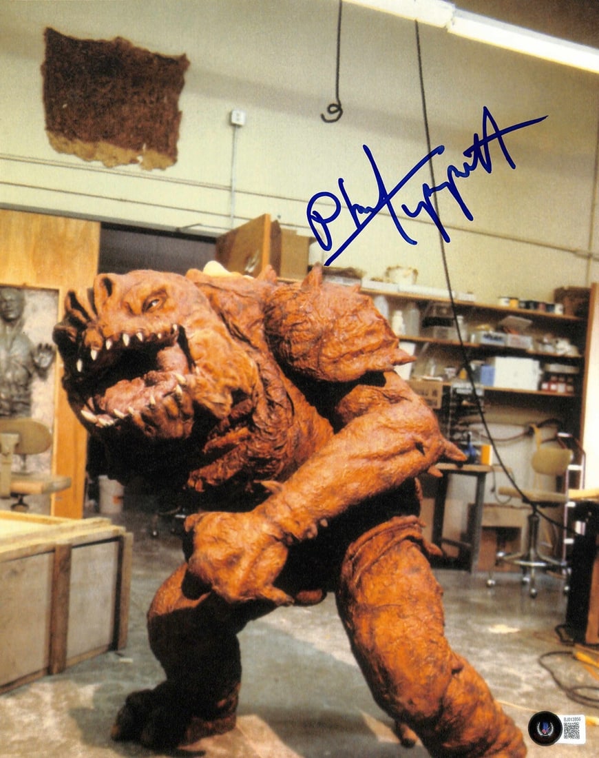 Phil Tippett Signed Star Wars Rancor Concept Photo 11x14 BECKETT Certified: Phil Tippett Signed Star Wars Rancor Concept Photo 11x14 BECKETT Certified This stunning 11x14 color photograph features a concept costume design of the Rancor from Star Wars: Return of the Jedi, sign
