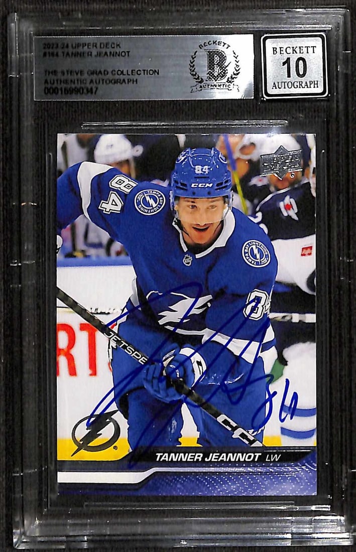 Autographed 2023-24 Upper Deck #164 Hockey Card Beckett 10 Tanner Jeannot: Autographed 2023-24 Upper Deck #164 Hockey Card Beckett 10 Tanner Jeannot This 2023-24 Upper Deck #164 sports trading card features an authentic blue permanent marker signature from Tampa Bay Lightnin