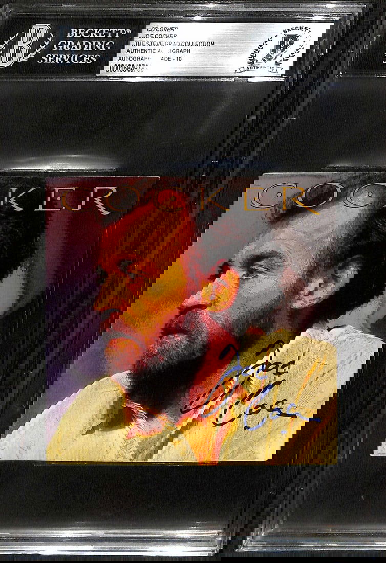Joe Cocker Autographed CD Booklet Beckett Grade 10: Joe Cocker Autographed CD Booklet Beckett Grade 10 This is a signed CD booklet by the legendary musician Joe Cocker, authenticated by Beckett with a perfect grade of 10. The item features a color book