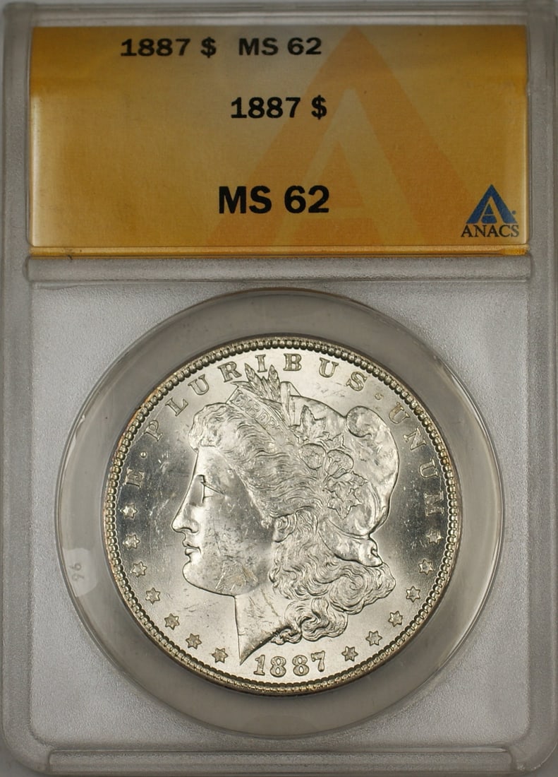 1887 Silver Morgan Dollar Coin Graded MS-62 by ANACS: 1887 Silver Morgan Dollar Coin Graded MS-62 by ANACS This is an 1887 Morgan Silver Dollar $1 coin, certified by ANACS with a grade of MS 62. The coin is uncirculated and was minted in Philadelphia. It