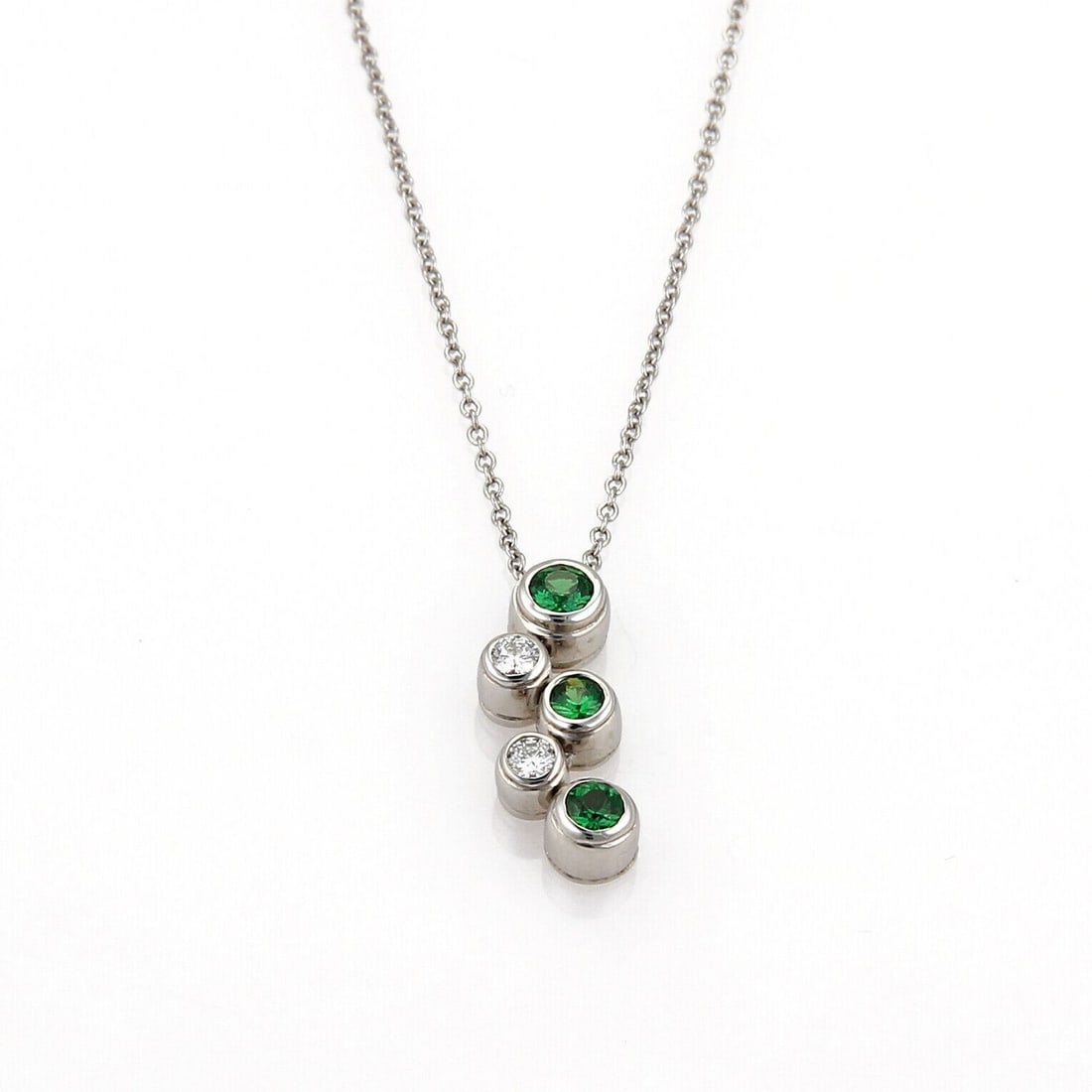 Platinum Pendant Necklace with Bubble Diamond and Tsavorite by Tiffany & Co.: Platinum Pendant Necklace with Bubble Diamond and Tsavorite by Tiffany & Co. This Tiffany & Co. Bubble Diamond Tsavorite Platinum Pendant Necklace showcases a distinctive pendant featuring a 0.25ct ts
