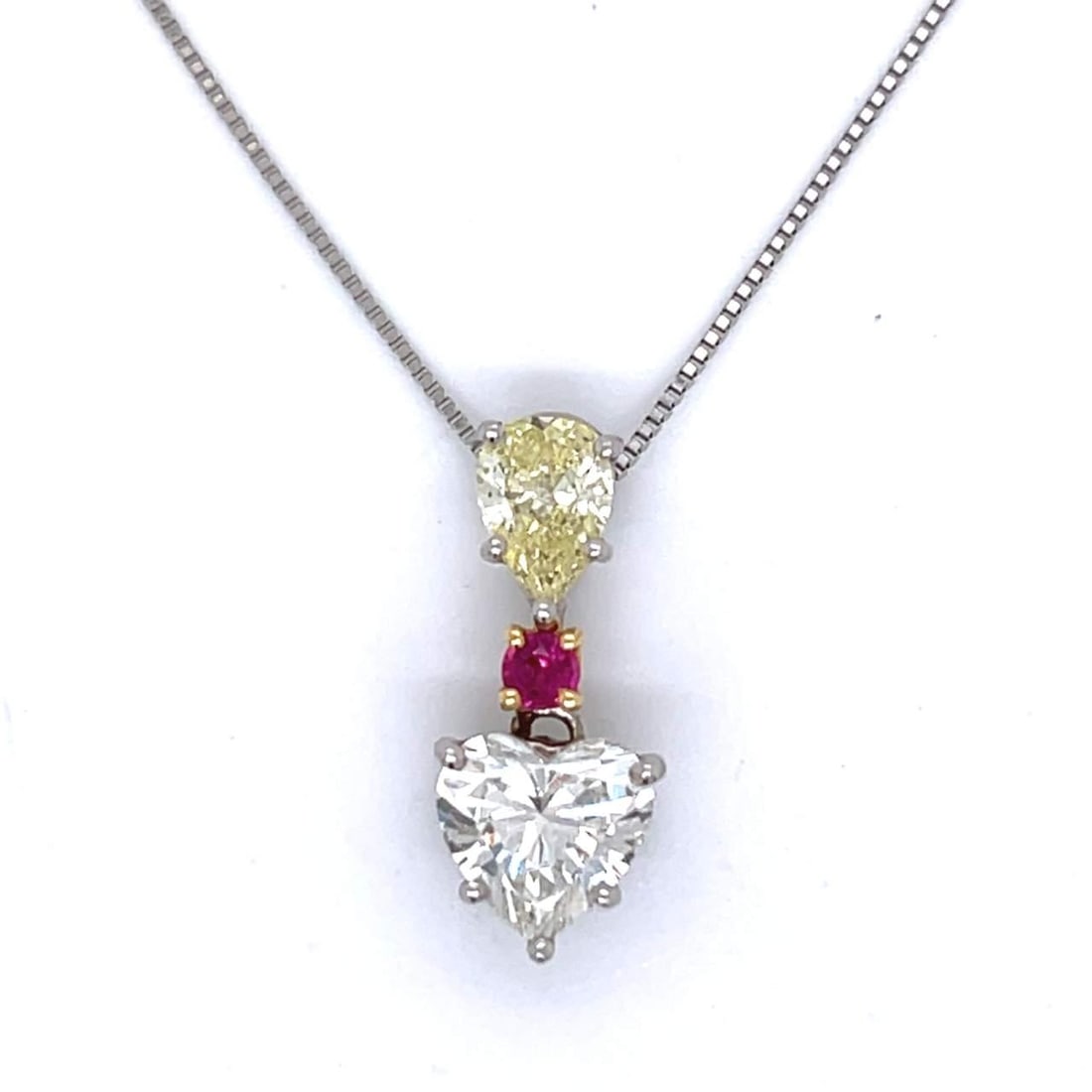 Platinum 18K Heart Diamond Ruby Necklace 1.90 Ct 0.70 Ct Fancy Yellow: Platinum 18K Heart Diamond Ruby Necklace 1.90 Ct 0.70 Ct Fancy Yellow This exquisite necklace features a stunning combination of platinum and 18K gold, adorned with a remarkable heart-shaped diamond w