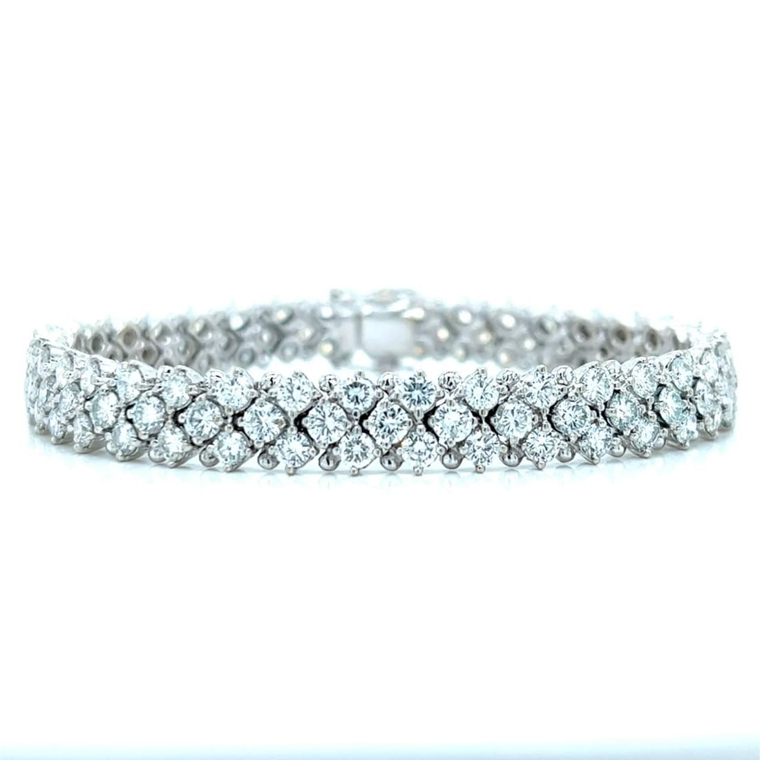 18K White Gold 12.00 Ct Diamond Bracelet with 111 Diamonds: 18K White Gold 12.00 Ct Diamond Bracelet with 111 Diamonds This exquisite 18K White Gold bracelet is adorned with a stunning array of 111 diamonds, totaling approximately 12.00 carats. The diamonds fe