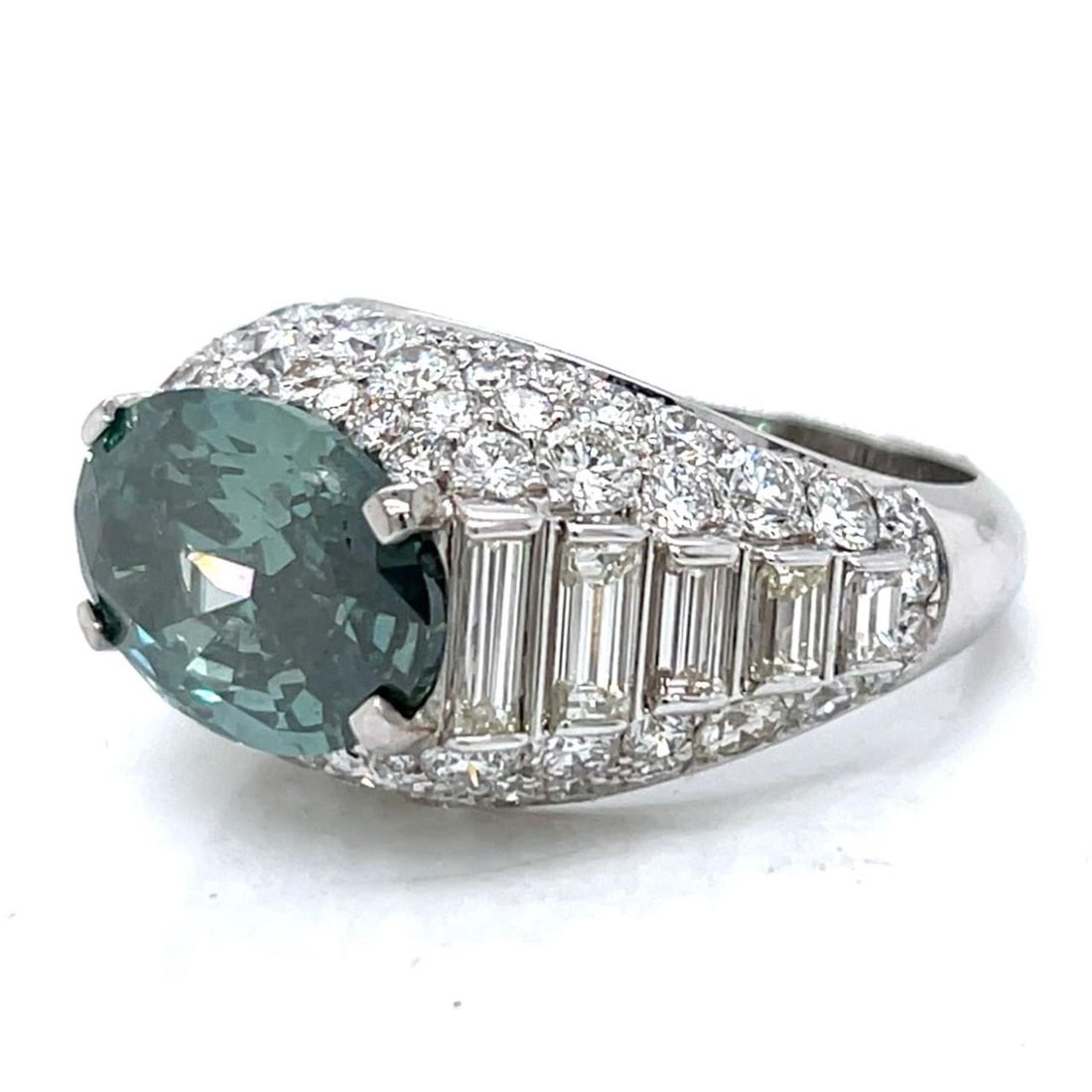 GIA Certified 7.09 Ct Fancy Deep Grayish Green Diamond Ring in 18K White Gold: GIA Certified 7.09 Ct Fancy Deep Grayish Green Diamond Ring in 18K White Gold This stunning ring features a GIA Certified 7.09 Ct. oval diamond with a Fancy Deep Grayish Green color, expertly set in l