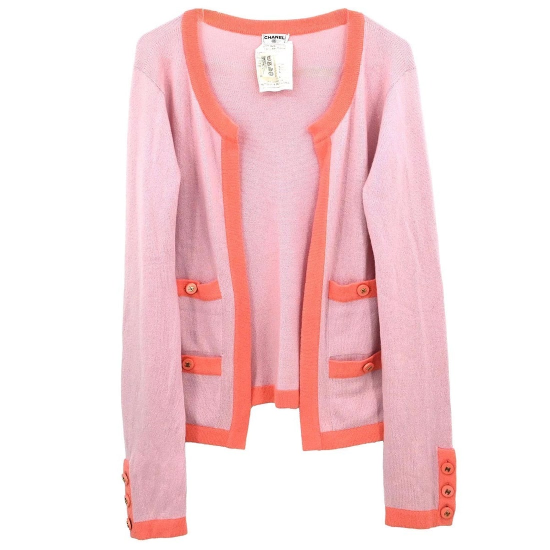 Pink Cashmere Knit Cardigan by Chanel with Logo Buttons: Pink Cashmere Knit Cardigan by Chanel with Logo Buttons This vintage Chanel cardigan is crafted from 100% cashmere in a soft pink knit. Featuring long sleeves and button logo accents, it is designed f