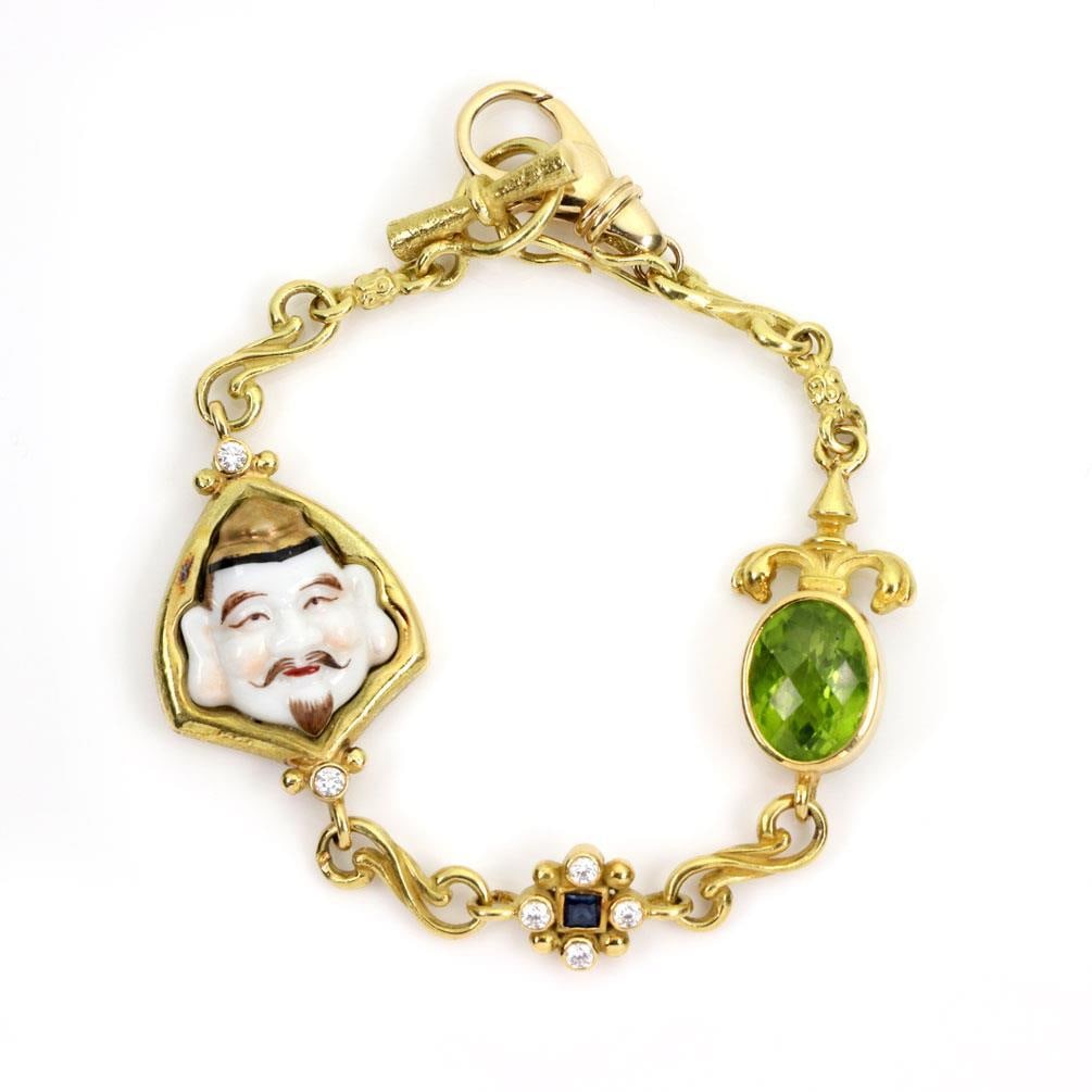 Tesora 18k Yellow Gold Diamond Peridot Enamel Charm Bracelet 9.72ct: Tesora 18k Yellow Gold Diamond Peridot Enamel Charm Bracelet 9.72ct Discover the elegance of this contemporary Tesora bracelet, meticulously crafted from 18k yellow gold. The bracelet features a scrol