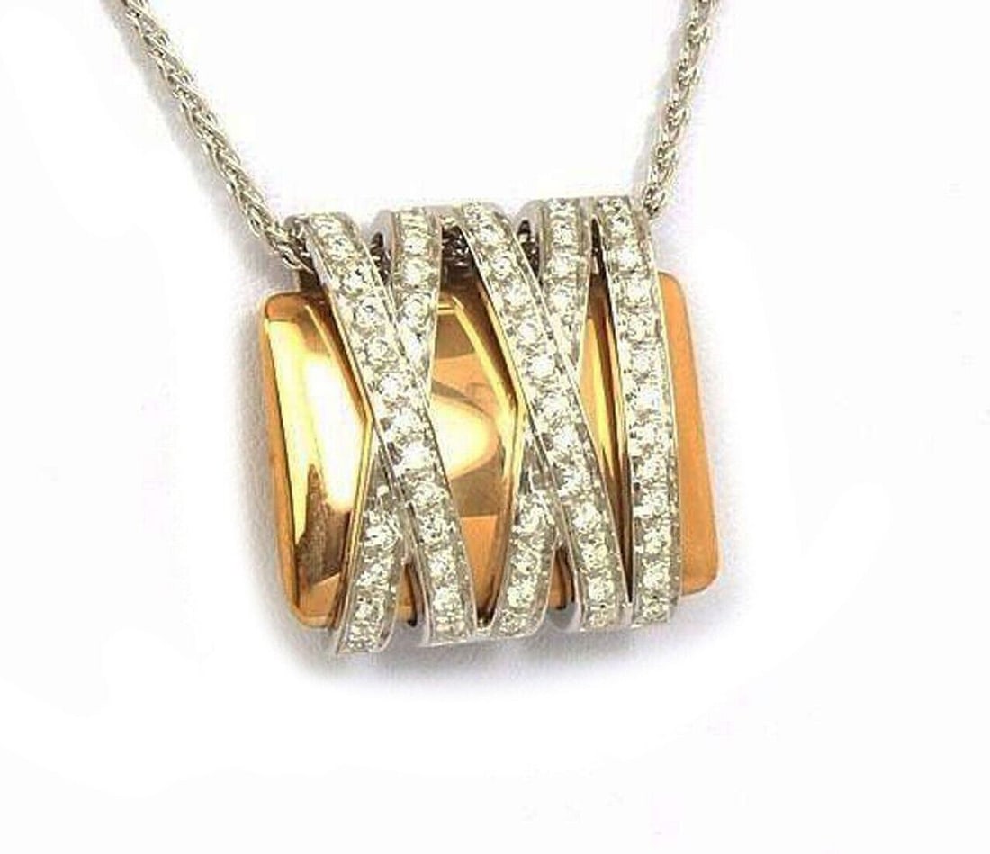 Diamond Pendant Necklace in 18k Two Tone Gold by Koesis Signed: Diamond Pendant Necklace in 18k Two Tone Gold by Koesis Signed This pendant necklace features a wrapped design crafted in 18k white and rose gold, adorned with 0.67 carats of natural diamonds. The pie