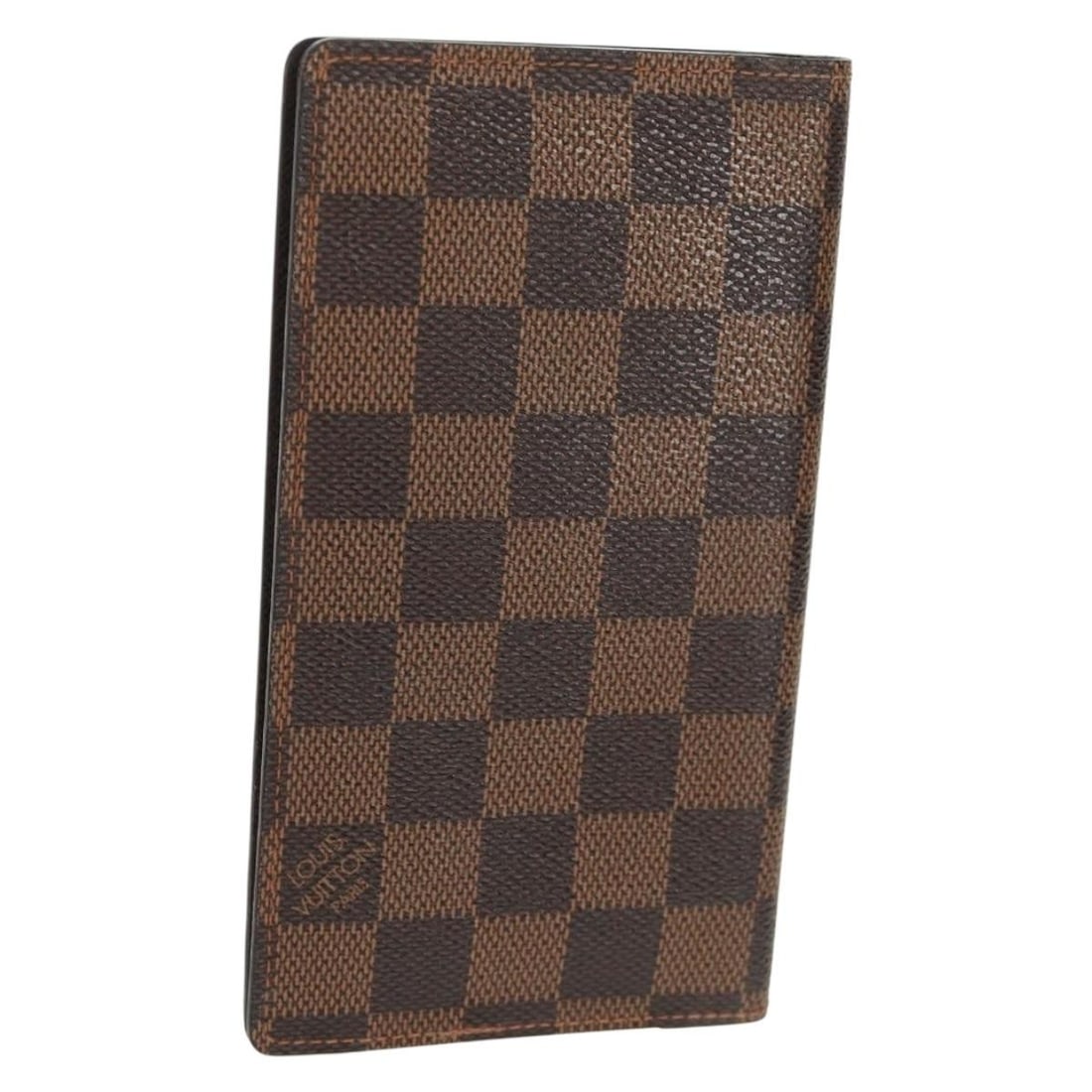 Damier Ebene Canvas Note Cover by Louis Vuitton Model R20703: Damier Ebene Canvas Note Cover by Louis Vuitton Model R20703 This Louis Vuitton Damier Ebene Agenda Poche Note Cover features the classic Damier Ebene canvas in a stylish brown color. The compact desi