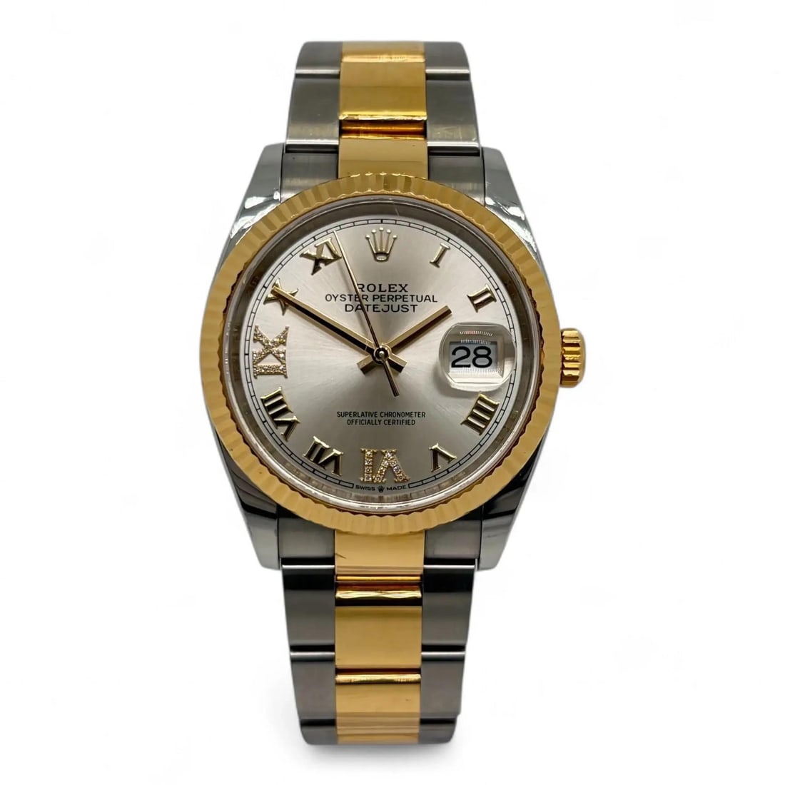 Rolex Datejust 36 Silver Roman VI IX Diamond Dial Two Tone Gold Steel Watch 126233: Rolex Datejust 36 Silver Roman VI IX Diamond Dial Two Tone Gold Steel Watch 126233 This Rolex Datejust 36 wristwatch features a luxurious combination of 18K yellow gold and stainless steel, complement
