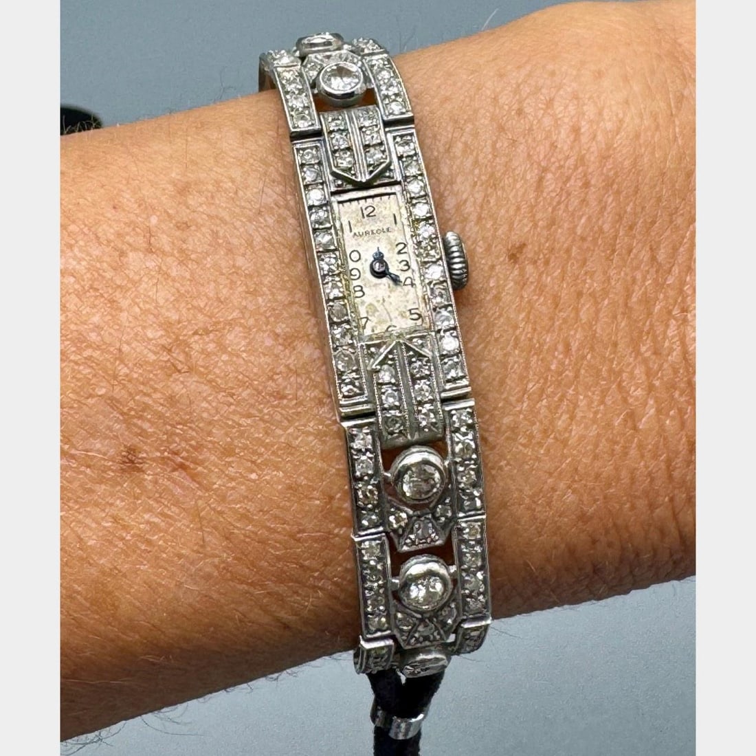 Art Deco Platinum and Diamond Cocktail Watch by AUREOLE: Art Deco Platinum and Diamond Cocktail Watch by AUREOLE This Art Deco cocktail watch by Aureole is crafted from platinum and adorned with 106 diamonds totaling approximately 2.50 carats, featuring F-J