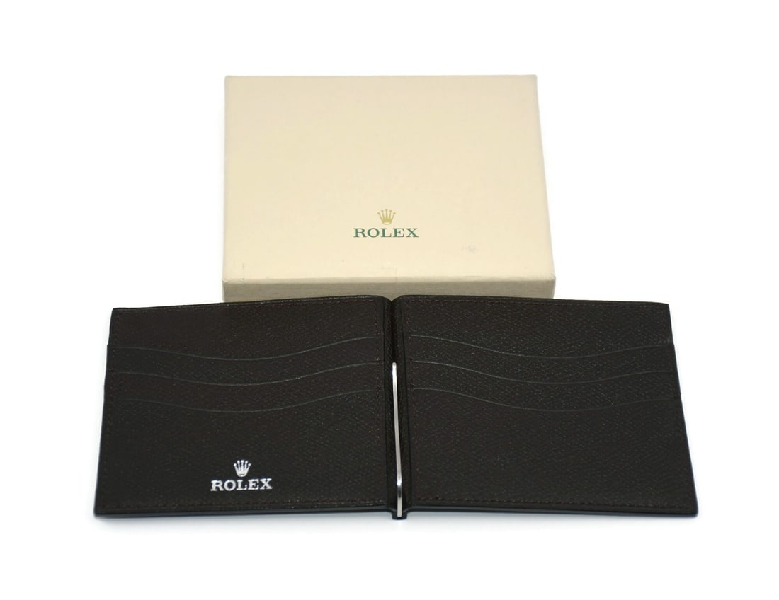 Rolex Authentic Brown Leather Wallet with Box 4x3.5 Inches: Rolex Authentic Brown Leather Wallet with Box 4x3.5 Inches Discover this authentic Rolex Brown Leather Wallet, a perfect blend of elegance and functionality. Crafted from premium leather, this wallet