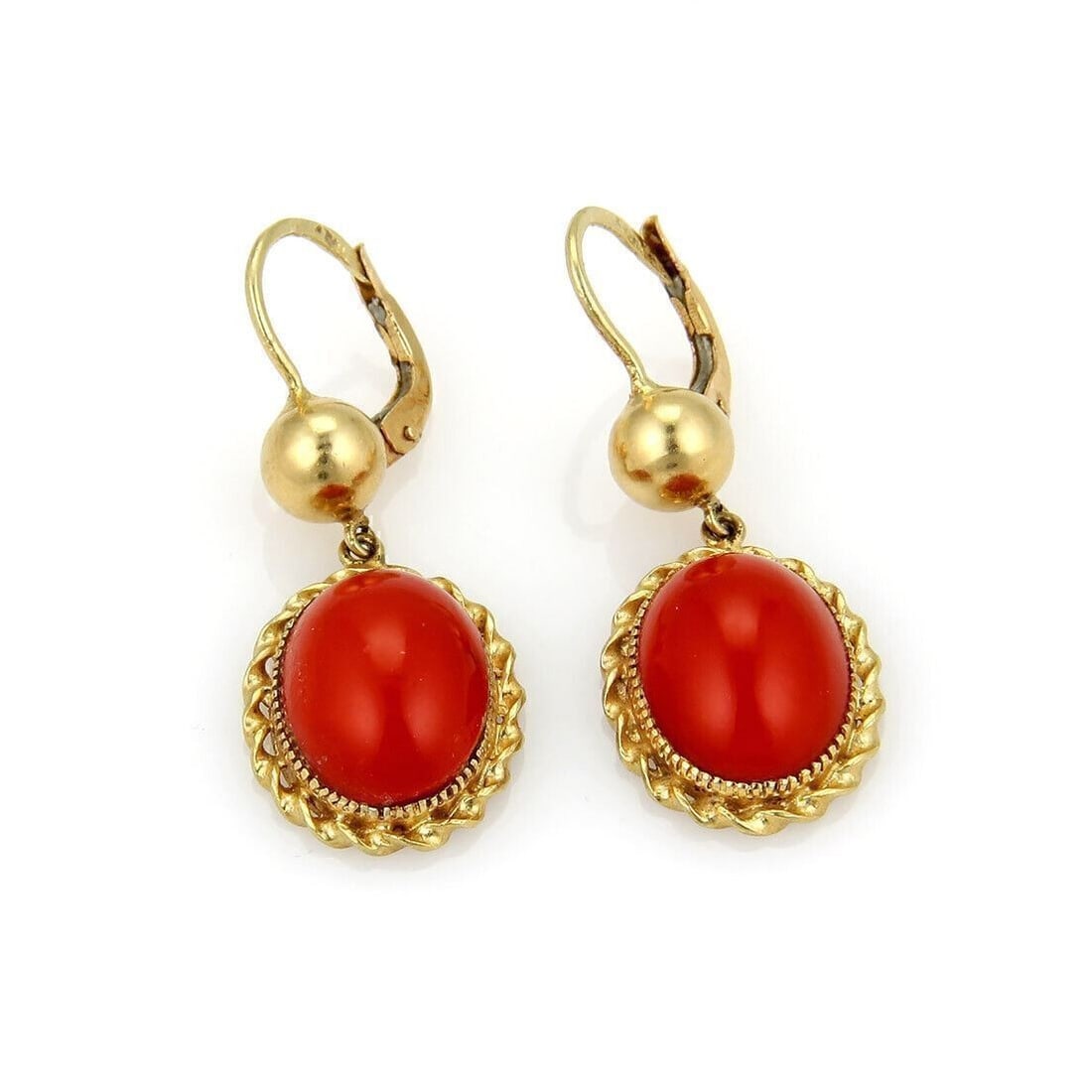 Vintage Oval Blood Coral Drop Earrings in 18k Yellow Gold: Vintage Oval Blood Coral Drop Earrings in 18k Yellow Gold These vintage dangle earrings feature oval blood coral stones set in 18k yellow gold. The original design highlights the elegant movement and